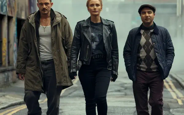 HD PC desktop wallpaper featuring Orlando Bloom, Bryce Dallas Howard, and Nick Mohammed in a scene from the movie Deep Cover walking through an urban alley.