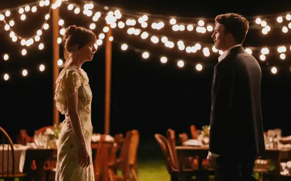 Scene from the movie Materialists featuring Dakota Johnson and Chris Evans, illuminated by string lights at an outdoor evening event, presented in 4K Ultra HD.