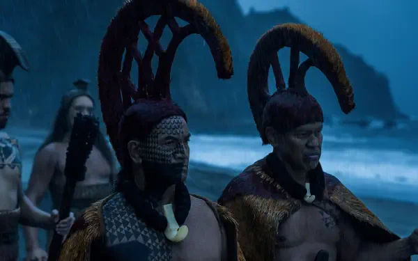 HD PC desktop wallpaper featuring a dramatic scene from the TV show Chief of War, with characters in traditional warrior attire set against a coastal backdrop.