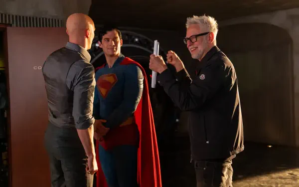 Behind-the-scenes moment from Superman (2025) featuring a director capturing a scene with Superman and another character, presented in 8K Ultra HD PC desktop wallpaper quality.