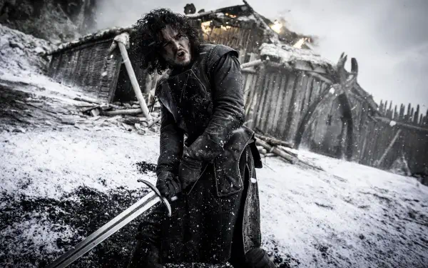 HD Game of Thrones PC wallpaper featuring a snowy battle scene with a warrior gripping a sword amidst a burning, collapsing wooden fortress.