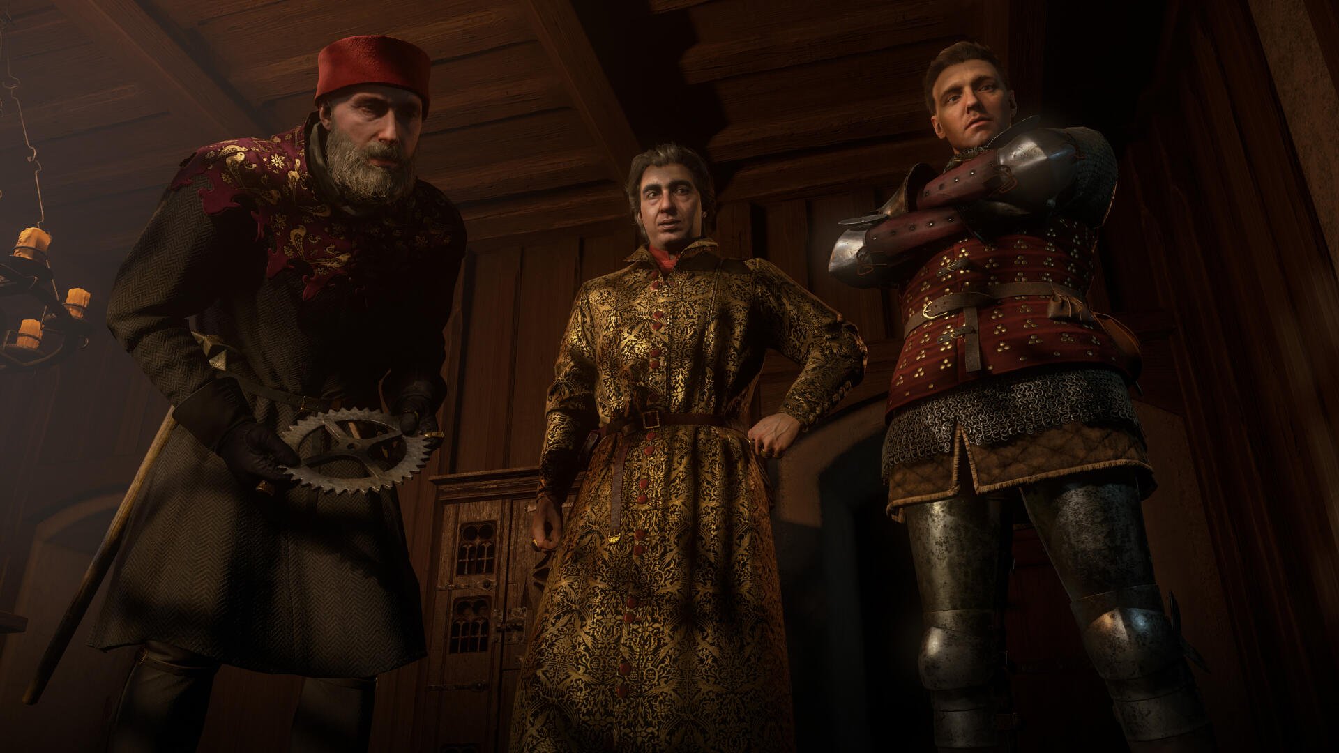4K Ultra HD PC desktop wallpaper from the video game Kingdom Come: Deliverance II — low-angle view of three armored, richly dressed medieval men standing in a dim, wooden hall, stern faces.