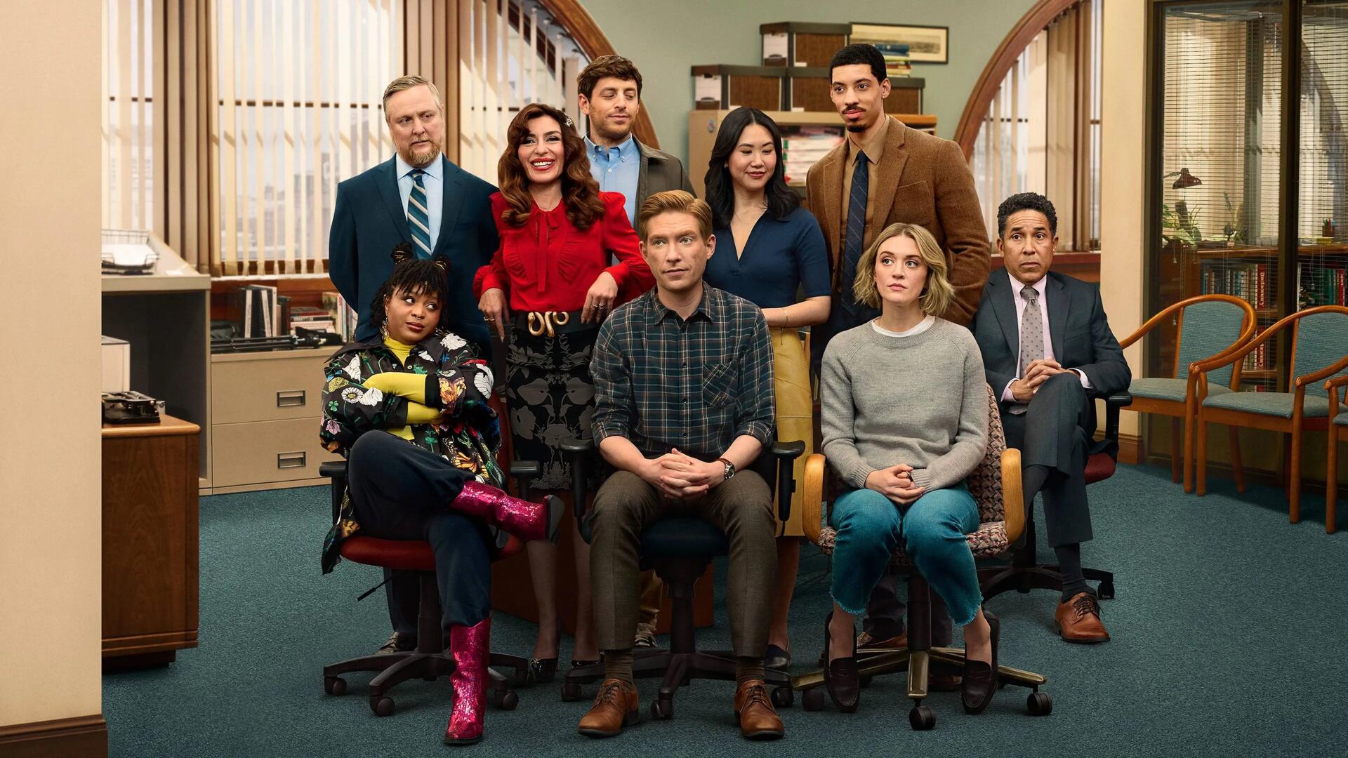 Promotional 4K Ultra HD PC desktop wallpaper for The Paper showing nine newsroom staff posed in an office with desks, bookshelves, warm lighting and retro decor.