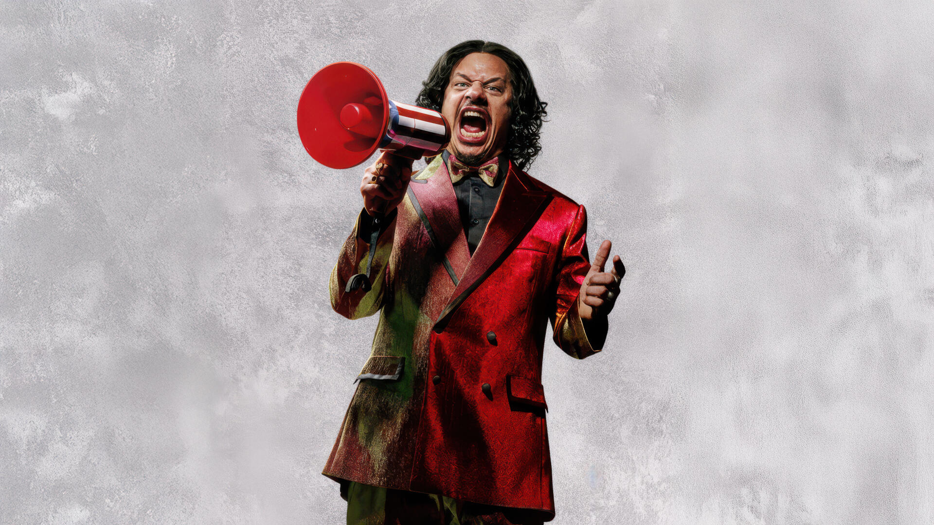 Street Fighter (2026) 5K Ultra HD PC desktop wallpaper: a person in a red suit shouting into a red megaphone against a cloudy gray backdrop.