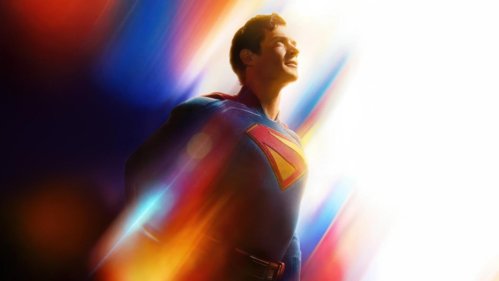 4K Ultra HD PC desktop wallpaper of Superman (2025): the hero in blue suit and red cape, smiling amid vibrant streaks of light and color.