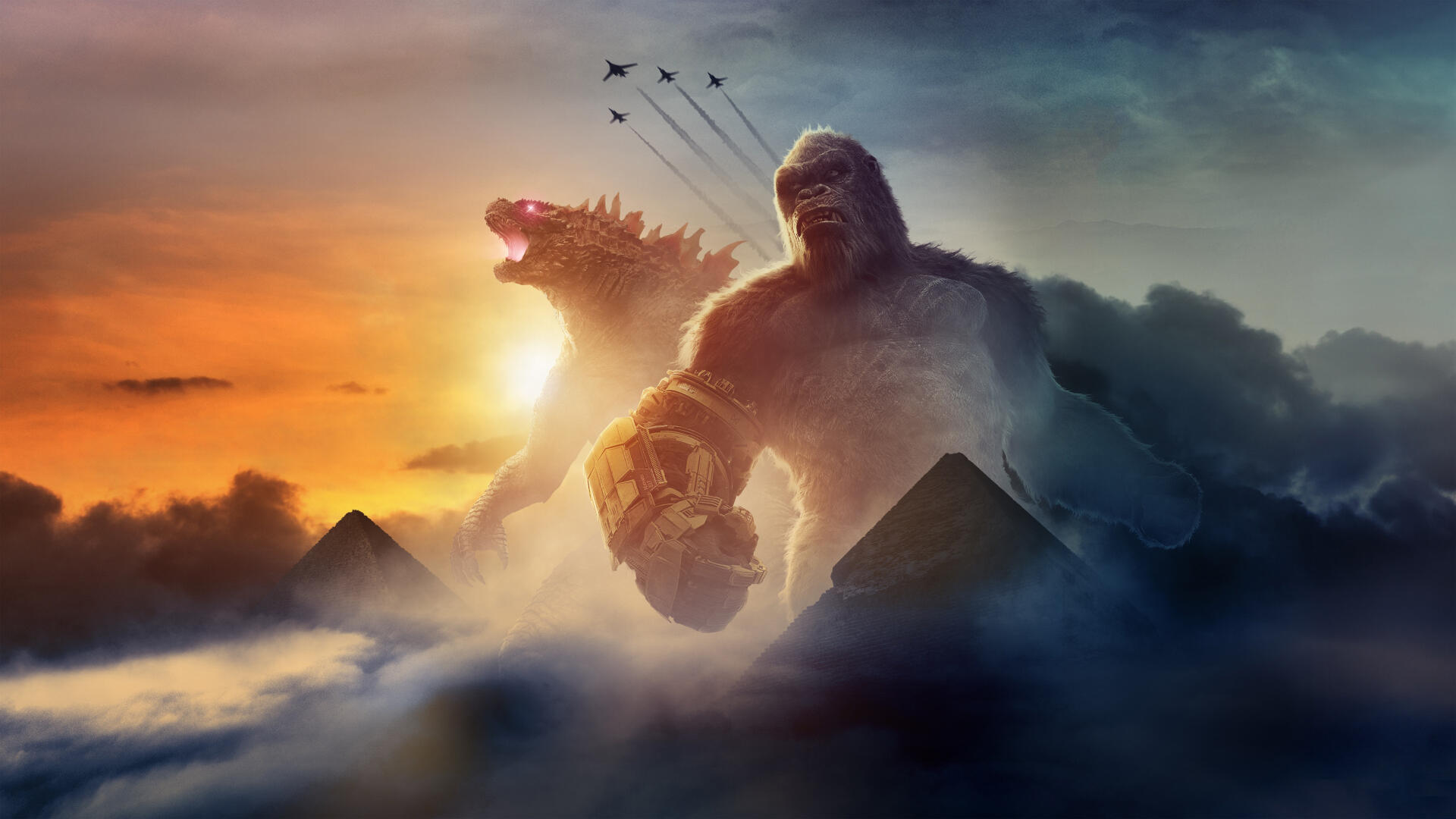 Godzilla x Kong: The New Empire 4K Ultra HD PC wallpaper — towering Kong and roaring Godzilla rise from clouds at sunset, jets streak overhead and pyramid silhouettes dot the horizon.