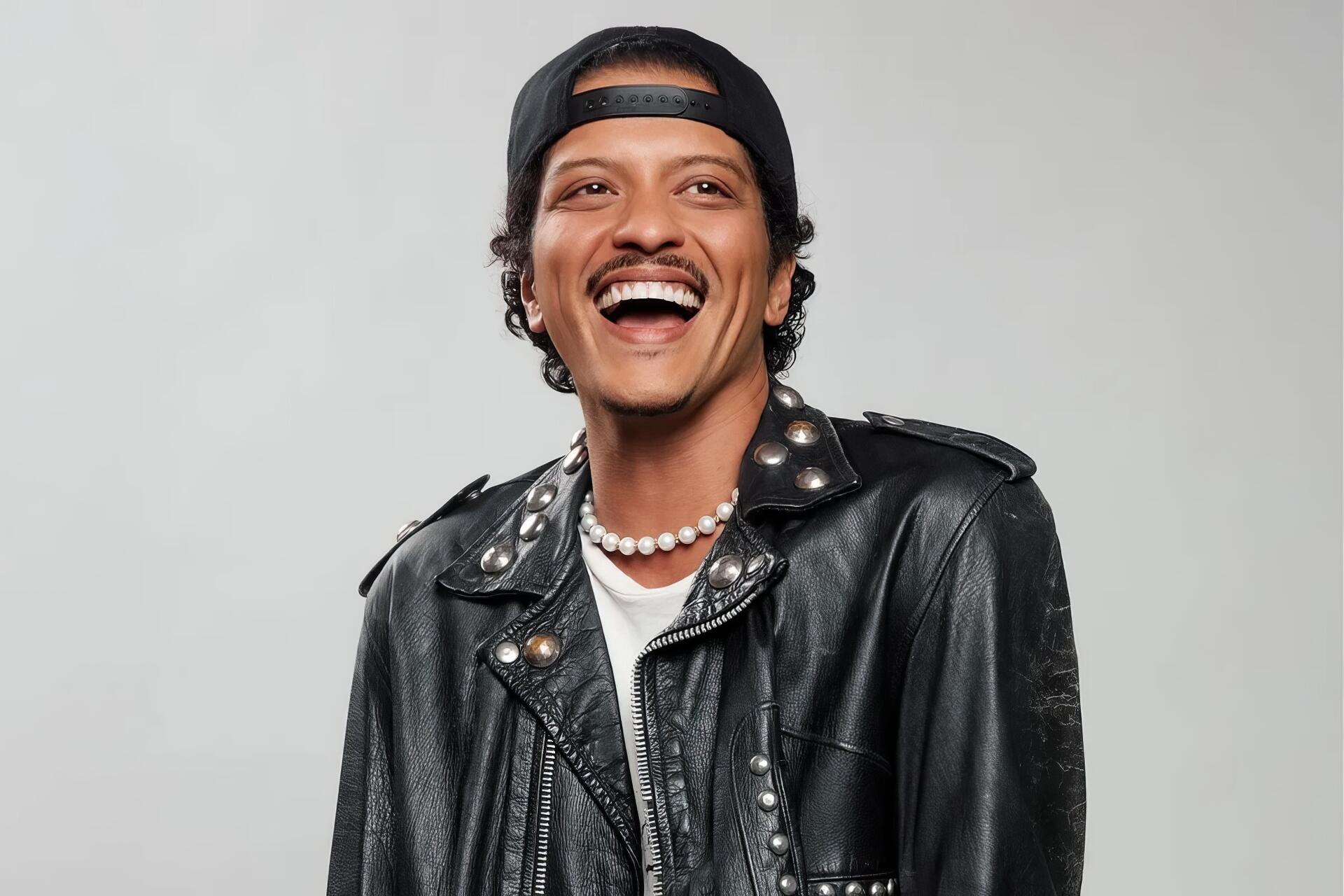 HD PC desktop wallpaper of a smiling music celebrity in a black leather jacket, backward cap and pearl necklace, posed against a light gray background.
