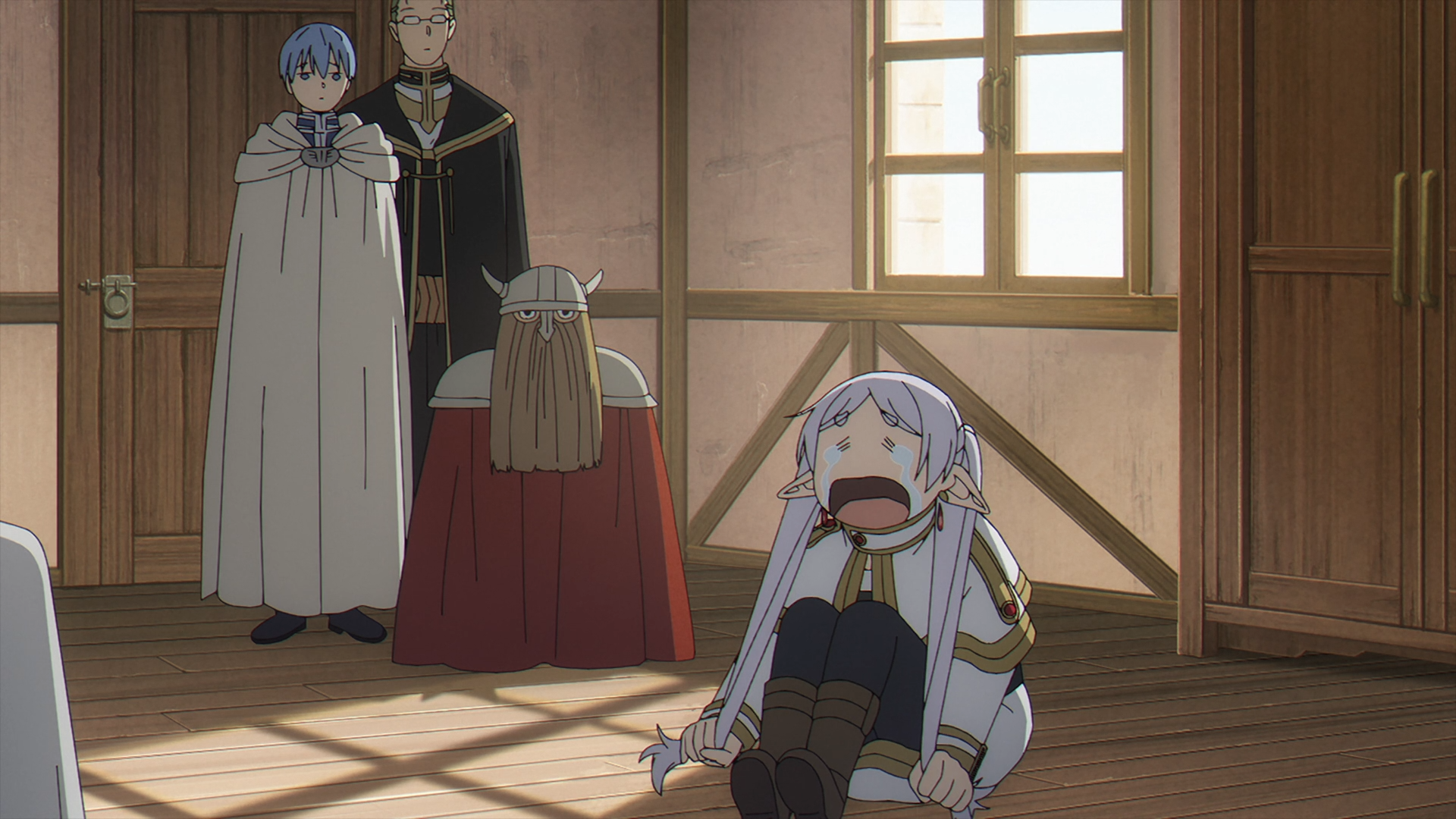HD PC desktop wallpaper from the anime Frieren: Beyond Journey's End showing Frieren sprawled on a wooden floor crying while two cloaked companions stand in a sunlit room.