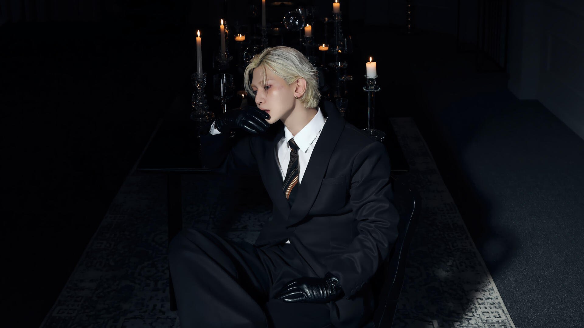 K-pop ATEEZ-inspired portrait — blond figure in a black suit and gloves seated amid gothic candlelight; 4K Ultra HD PC desktop wallpaper/background.
