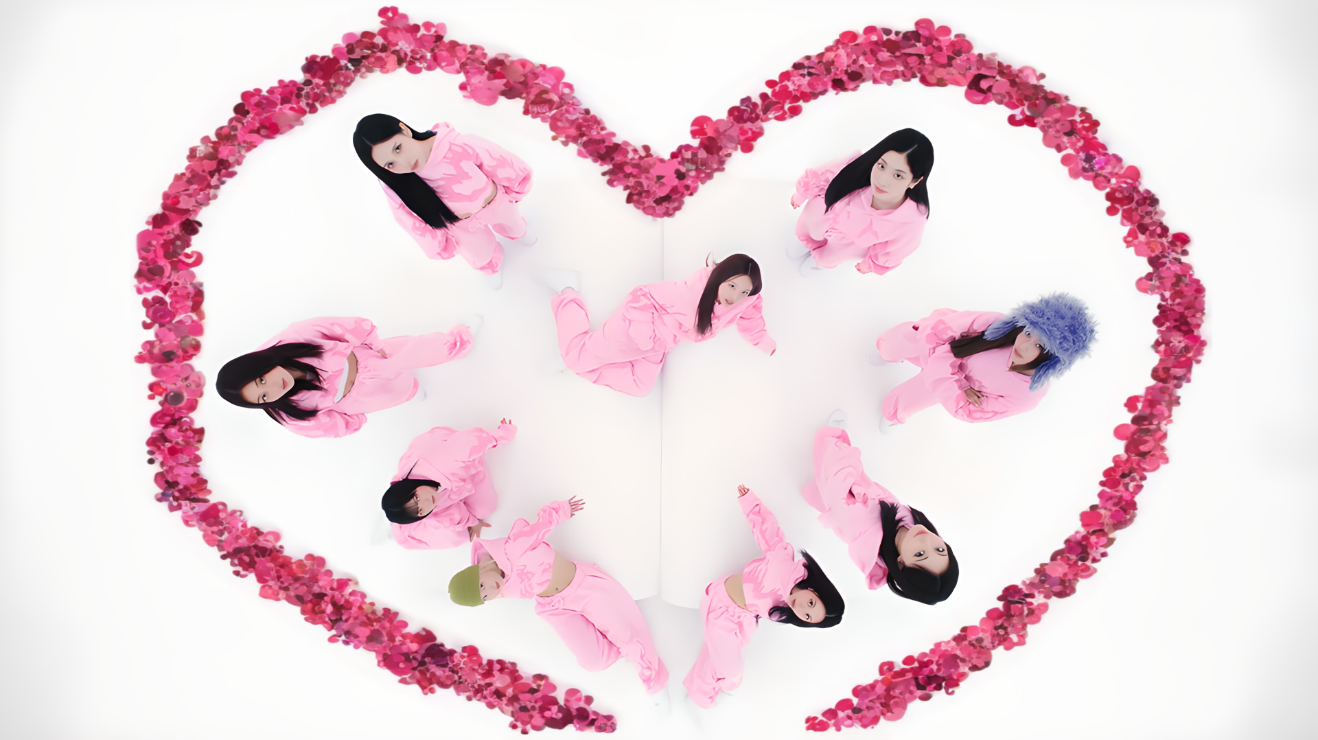 K-pop–inspired album-style 4K desktop wallpaper: nine performers in pink outfits arranged inside a heart of pink roses on a white background.
