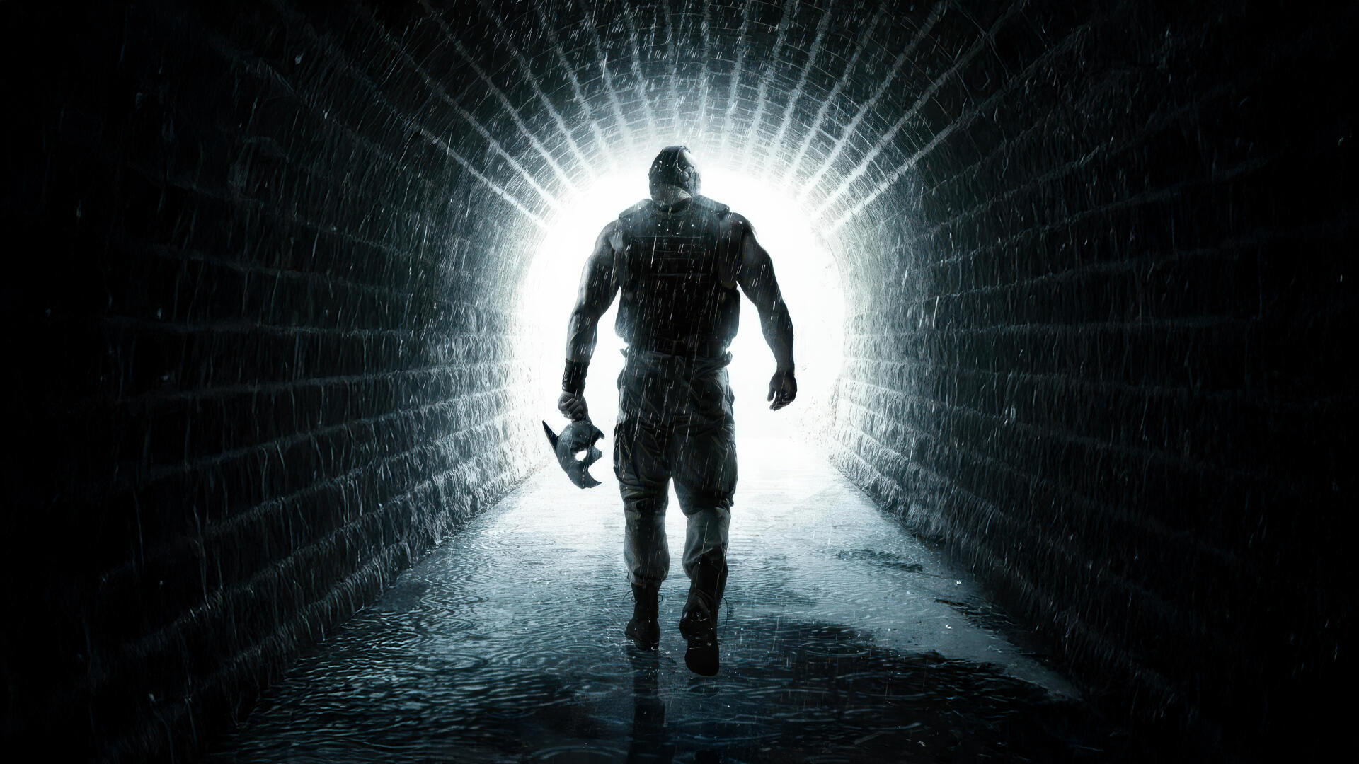 Batman: The Dark Knight Rises — silhouetted Batman strides from a brick tunnel into blinding light, holding a Batarang. 4K Ultra HD PC desktop wallpaper/background.