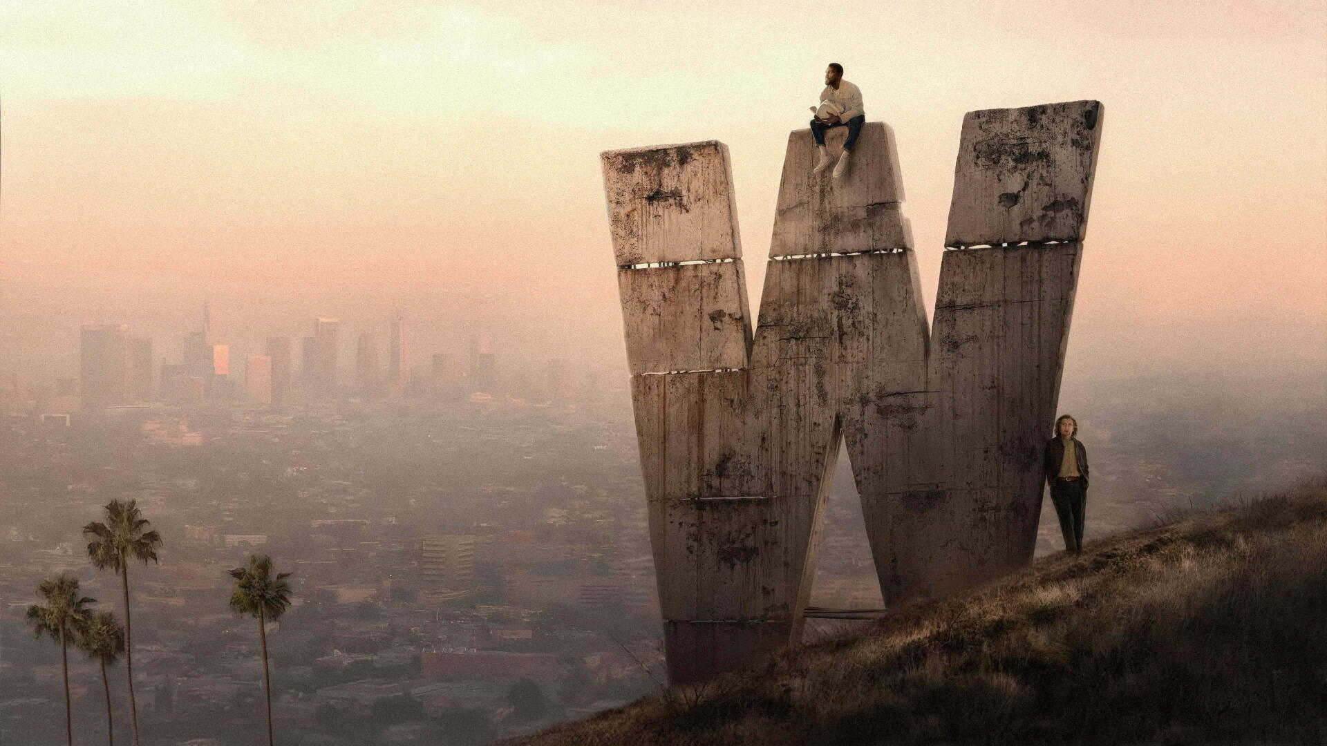 Wonder Man (2026) 4K Ultra HD PC desktop wallpaper/background: sunset haze over a sprawling city, a weathered giant 'W' monolith on a hill with two small figures nearby.