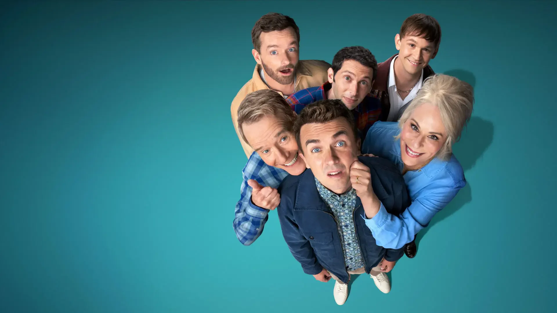 4K Ultra HD PC wallpaper titled Malcom in the Middle: Life's Still Unfair — seven people in casual clothes clustered and looking up at the viewer on a teal background.