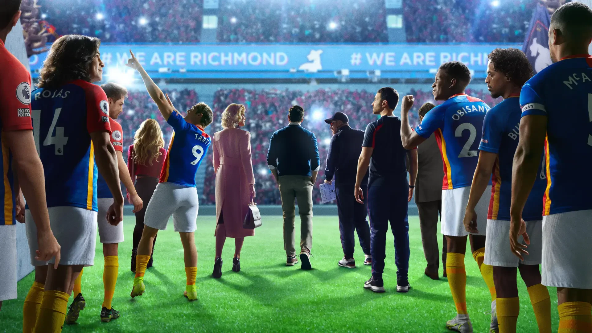 Ted Lasso 4K Ultra HD PC desktop wallpaper: the coach and his squad walk onto a vibrant stadium pitch beneath a WE ARE RICHMOND banner.