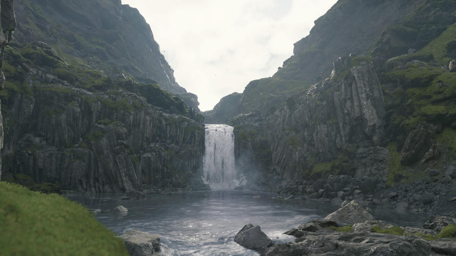 4K Ultra HD PC desktop wallpaper and background, video game scene of a misty waterfall cascading between mossy basalt cliffs into a rocky pool under an overcast sky.