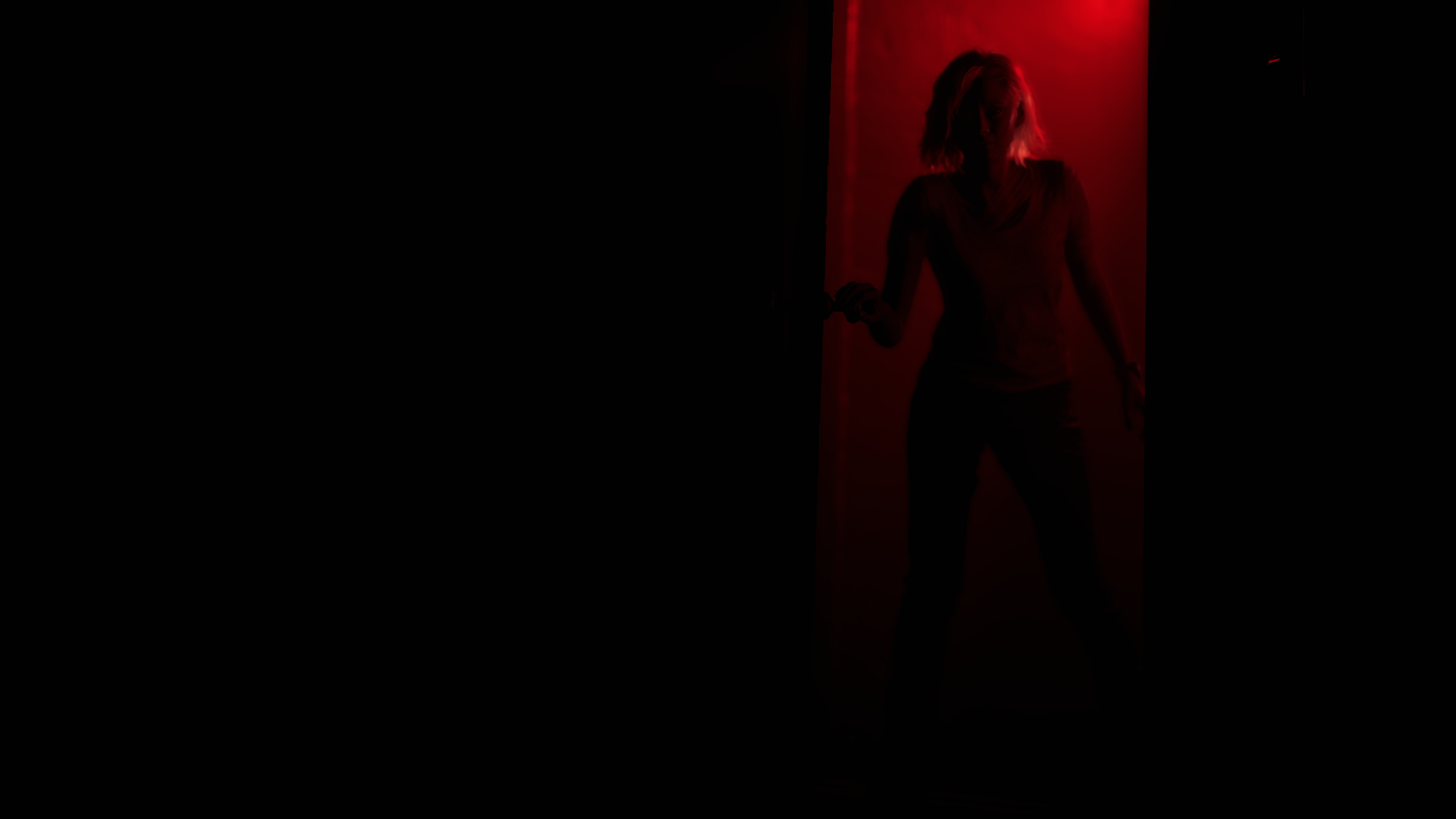 2K Quad HD PC wallpaper of Grace Ashcroft from Resident Evil Requiem: a shadowy female silhouette framed in a narrow red-lit doorway against an almost black background.