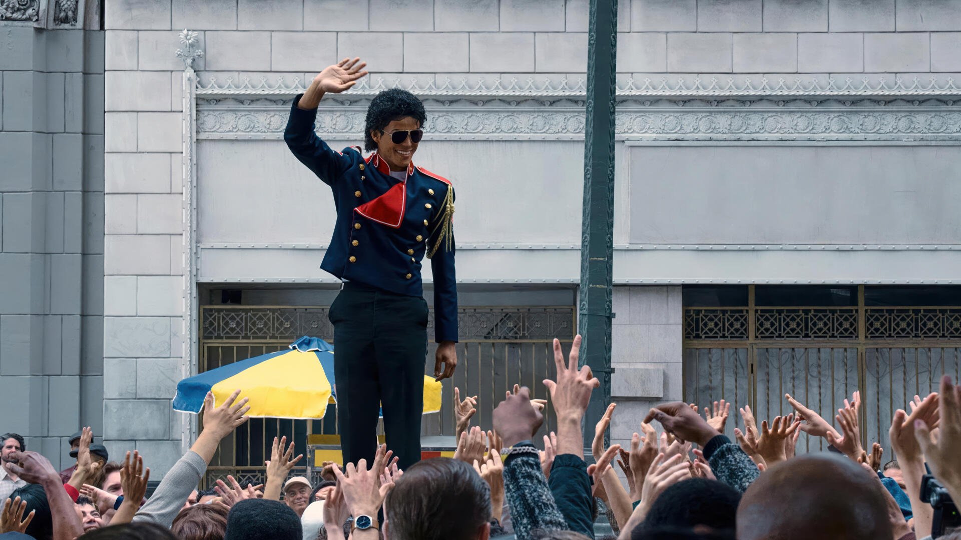 4K Ultra HD PC desktop wallpaper for the movie Michael (2026): costumed performer in a military-style jacket waves to a cheering city crowd.
