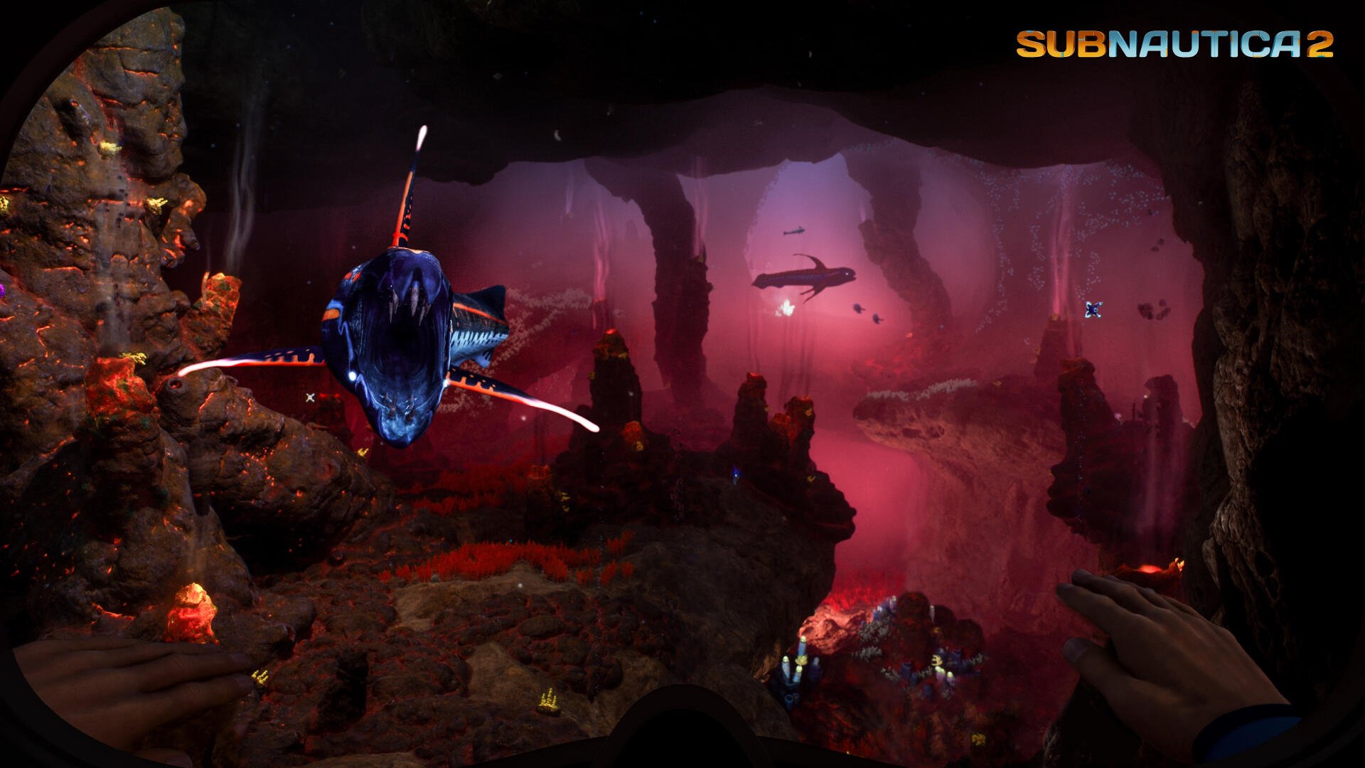 Subnautica 2 video game 4K Ultra HD PC wallpaper: crimson bioluminescent underwater cavern with rock pillars and a menacing fish.