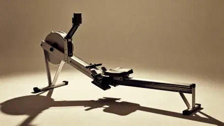 4K Ultra HD PC desktop wallpaper/background showing a single rowing machine casting a long shadow on a warm beige studio floor.