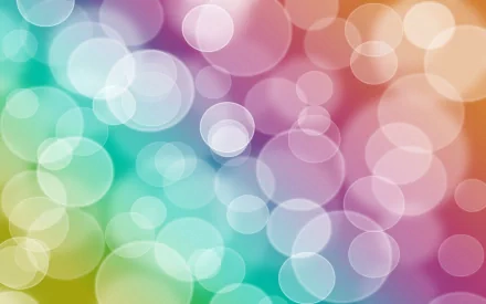 An abstract HD wallpaper featuring colorful bokeh circles in shades of green, pink, and blue, creating a dreamy, soft-focus background.