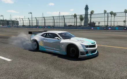 Bright daytime HD PC desktop wallpaper of a Chevrolet Camaro drifting on a sunlit circuit in The Crew, blue-white livery kicking up smoke near palm-lined barriers.