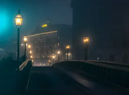 5K Ultra HD PC desktop wallpaper: nighttime city haze with a bridge lit by street lamps leading toward softly glowing buildings.