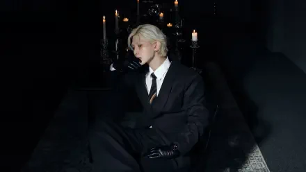 K-pop ATEEZ-inspired portrait — blond figure in a black suit and gloves seated amid gothic candlelight; 4K Ultra HD PC desktop wallpaper/background.