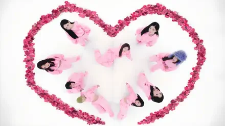 K-pop–inspired album-style 4K desktop wallpaper: nine performers in pink outfits arranged inside a heart of pink roses on a white background.
