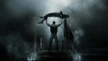 Batman: The Dark Knight Rises 4K Ultra HD PC desktop wallpaper — Batman stands in pouring rain on a rooftop, lifting a limp figure beneath dramatic storm clouds and distant city lights.