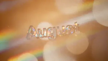 Translucent August lettering over warm golden bokeh and prism rainbows — 4K Ultra HD PC desktop wallpaper/background.