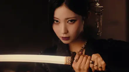 Moody 5K Ultra HD desktop wallpaper of a k-pop idol/Japanese model gripping a katana-like sword, intense stare, ornate hairpiece and dark cinematic lighting.