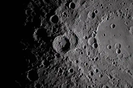 NASA Artemis II HD PC desktop wallpaper: high-definition view of the Moon’s heavily cratered surface with sharp shadows and overlapping impact basins.