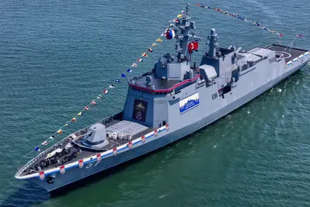HD desktop wallpaper: North Korean Choe Hyon-class guided-missile destroyer at sea, deck draped in signal flags during a military naval fleet ceremony.