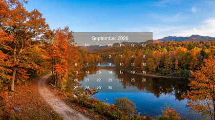 September 2026 calendar over a 5K Ultra HD PC desktop wallpaper and background: autumn lakeside with vibrant foliage, a winding dirt path and trees mirrored in the calm water.