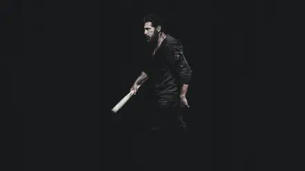 4K Ultra HD PC desktop wallpaper — The Punisher: One Last Kill: lone vigilante in dark clothes gripping a bat, emerging from deep black background.