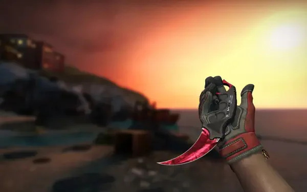 Counter-Strike 2 HD PC desktop wallpaper: gloved hand displays a red Karambit knife against a glowing sunset over a coastal map, video game background.