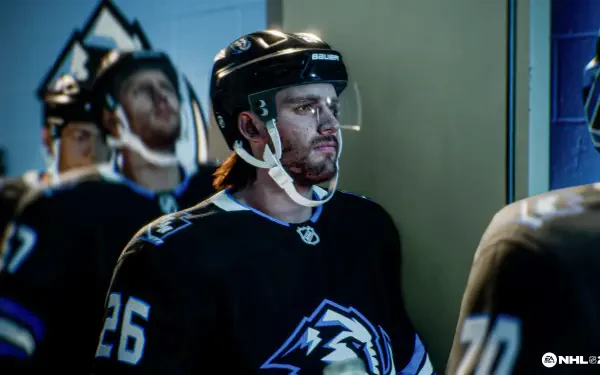 4K Ultra HD PC desktop wallpaper from NHL 26: close-up of a helmeted hockey player in a black #26 jersey in the tunnel, arena lighting and focused expression.
