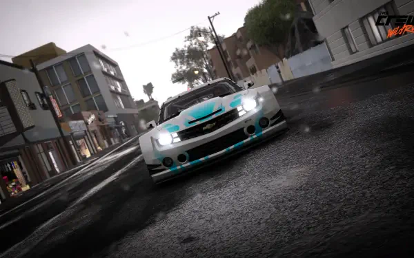 Low-angle Chevrolet Camaro racing through a rainy city circuit, wet reflections and motion blur — 2K Quad HD PC desktop wallpaper from The Crew.