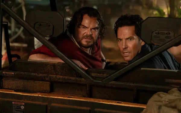 4K Ultra HD PC desktop wallpaper of Anaconda (2025): two actors in a jeep at night, tense expressions and jungle backdrop, gripping the windshield bars.