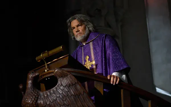 Bearded actor in purple priest robes at a pulpit from the movie Wake Up Dead Man: A Knives Out Mystery — 8K Ultra HD PC desktop wallpaper.