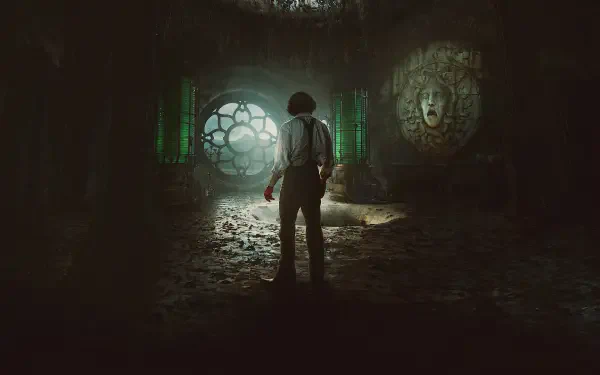 HD PC desktop wallpaper and background: lone figure in a ruined Gothic lab bathed in green light, facing a circular window and a carved face — movie Frankenstein (2025).