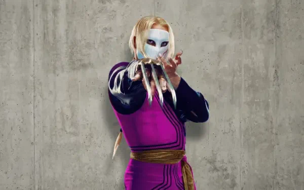 Street Fighter (2026) 2K Quad HD PC desktop wallpaper: masked fighter in purple outfit with long clawed gauntlet posing against a textured concrete wall.