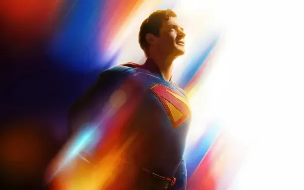 4K Ultra HD PC desktop wallpaper of Superman (2025): the hero in blue suit and red cape, smiling amid vibrant streaks of light and color.