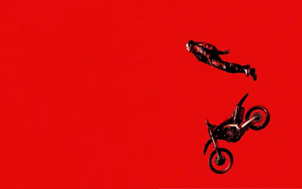 Mission: Impossible - Dead Reckoning Part One 4K Ultra HD PC desktop wallpaper: silhouette of a falling stunt rider above a tumbling motorcycle on a vivid red background.