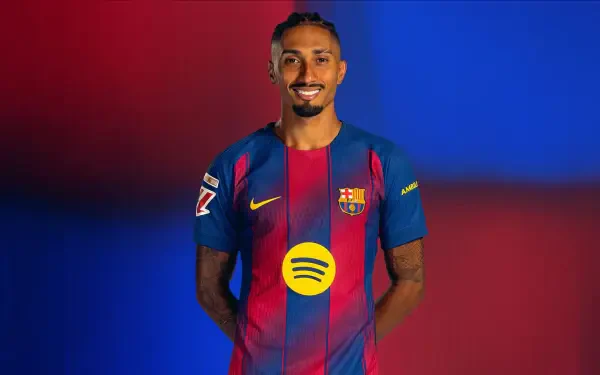 HD PC desktop wallpaper: smiling FC Barcelona soccer player in blue-and-red kit posed against a red-and-blue gradient background.