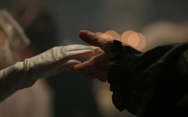 2K Quad HD Bridgerton TV show desktop wallpaper: a gloved hand and a bare hand reach to touch in a dim, intimate ballroom scene.