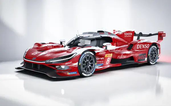 Red Toyota TR010 Hybrid race car with Toyota livery, studio-lit 4K Ultra HD PC desktop wallpaper/background.