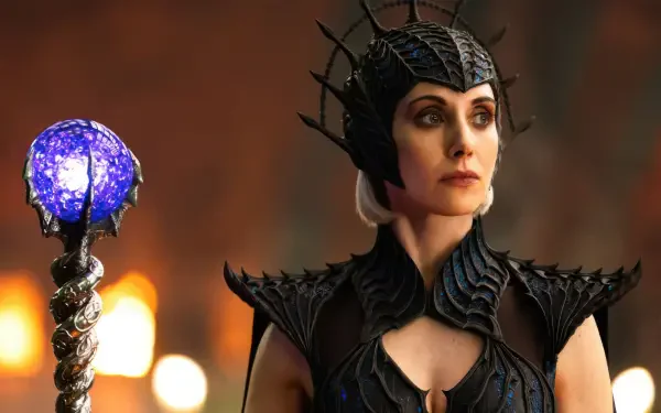 4K Ultra HD PC desktop wallpaper: armored wizard from Masters of the Universe (2026) wearing a horned crown and holding a glowing crystal staff, featuring an actress in the role.