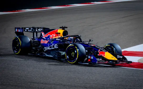 HD PC desktop wallpaper and background of a Red Bull Racing F1 car on track, speeding through a race turn — dynamic racing vehicle with Red Bull livery and sponsor logos.