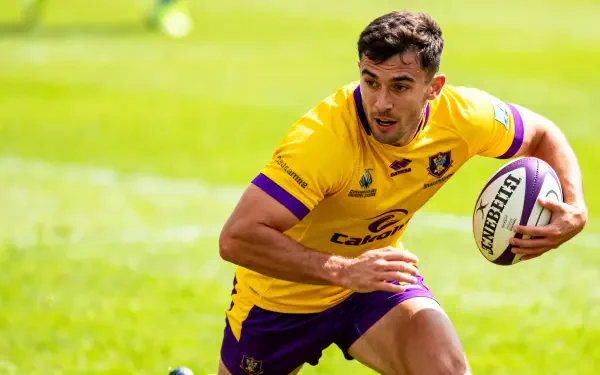 Rugby player in a yellow jersey sprinting with the ball across a sunlit grass field — 4K Ultra HD PC desktop wallpaper background.